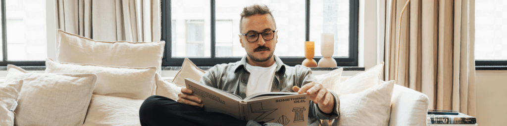 A business owner reading a book as part of their startup accelerator program.