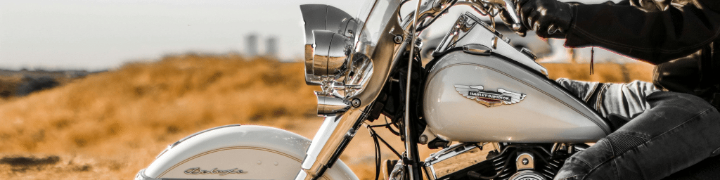 A person riding a Harley-Davidson motorcycle symbolizing the strong brand identity and personality.